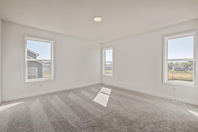 (*Photo of actual home) The primary bedroom has lots of beautiful natural lighting from all the windows! | Image 10
