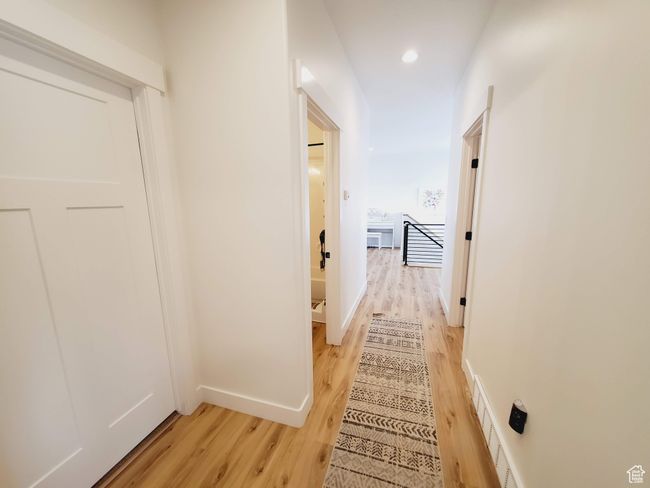 Hall featuring recessed lighting, visible vents, baseboards, and wood finished floors | Image 11