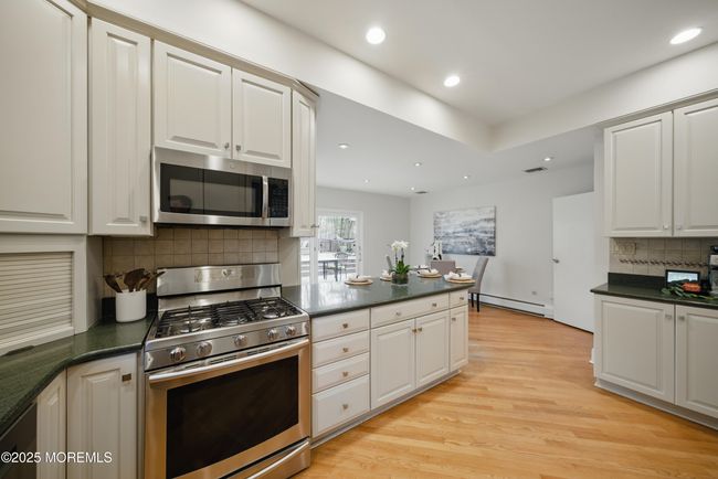 Eat in Kitchen with separate Dining, Coffee bar, SS appliances with sliders to LARGE deck with privacy and nature. | Image 8