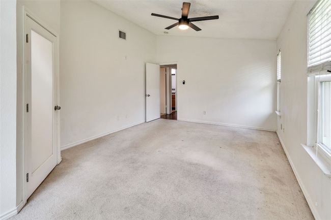 Unfurnished bedroom with lofted ceiling, carpet, and ceiling fan | Image 12