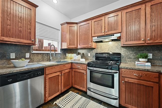 Stainless appliances throughout the kitchen including a deep stainless sink. | Image 10