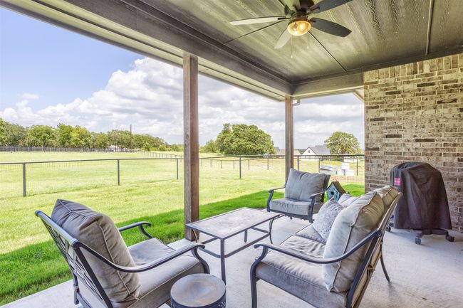 Your covered patio is where you can watch the deer play....Beautiful view from the back patio. | Image 25