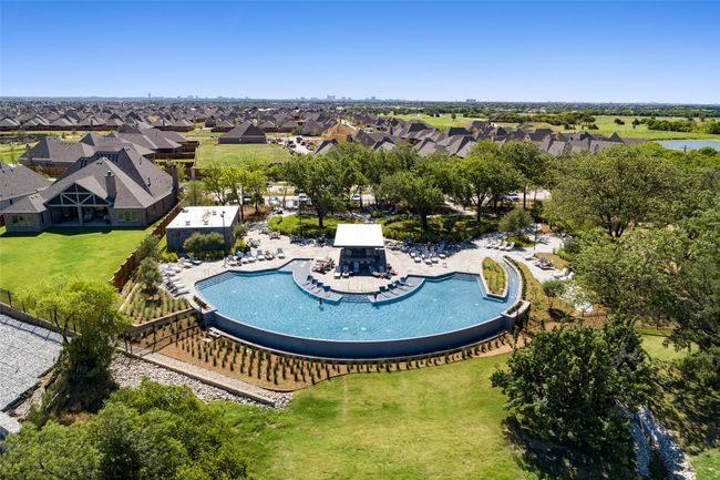 The Tribute is home to 3 different pools including this infinity pool overlooking Lake Lewisville with grilling area, fire pits, tanning ledge and loads of sitting space. You can also enjoy the Lochs Resort Pool, kids splash pad or hop on the Lake for a full day of relaxing. | Image 38