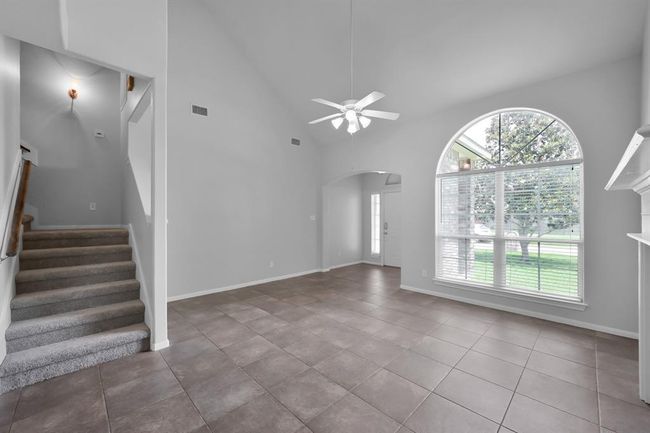 Headed back out toward the living room, you'll see that to the left, the staircase to the upstairs bedrooms subtly separates the space, creating a layout that feels both connected and defined. | Image 22