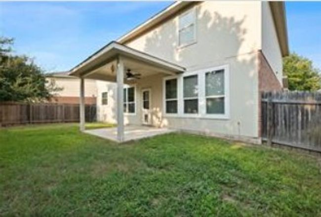 Rear view of house featuring a patio, a yard, stucco siding, a ceiling fan, and a fenced backyard | Image 25