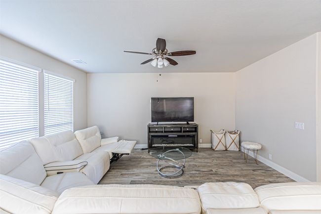Living area featuring ceiling fan, wood finished floors, and baseboards | Image 13