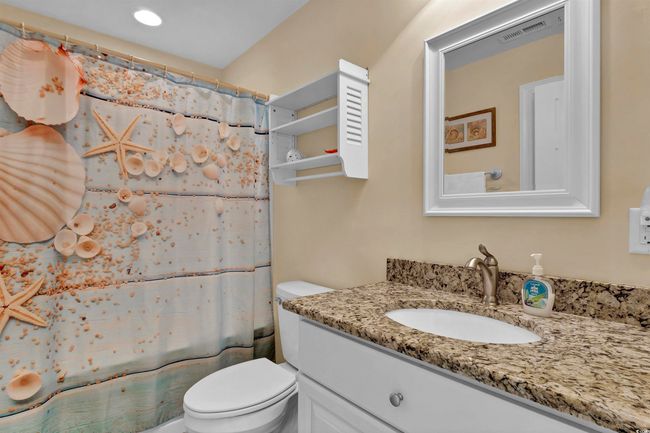 Bathroom with vanity and curtained shower | Image 20