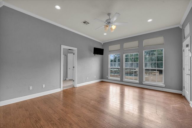 Unfurnished room with ornamental molding, ceiling fan, wood finished floors, and recessed lighting | Image 18