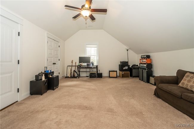 Additional living space with vaulted ceiling, a ceiling fan, and light carpet | Image 29