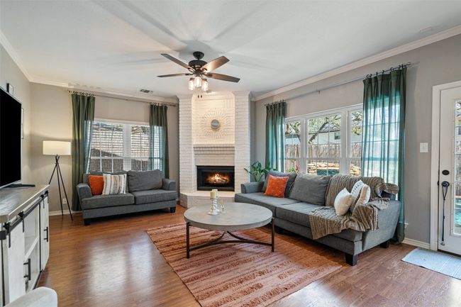 Living area featuring wood finished floors and crown molding | Image 20