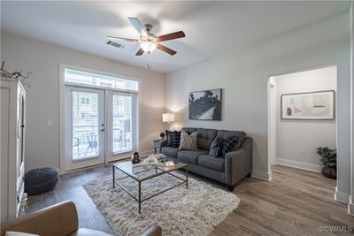 Living room featuring french doors, hardwood / wood-style flooring, and ceiling fan | Image 1