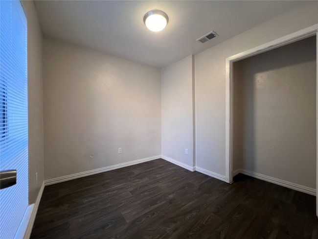 Spare room with dark wood finished floors and baseboards | Image 5