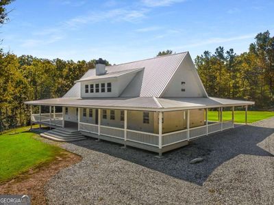 Take a look at this gorgeous 2 story farmhouse with a full wrap around porch | Image 3