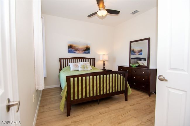 Third bedroom offers double closet, a ceiling fan and attractive flooring. | Image 19