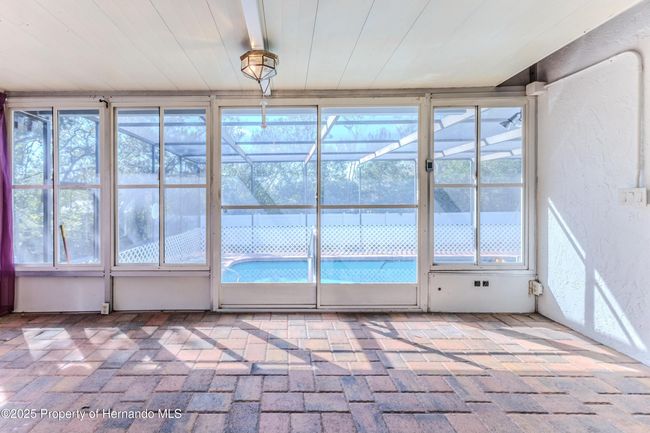 Paved Florida Room looking out to the Pool | Image 32