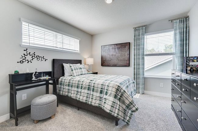 The third bedroom also features a walk-in closet and extra light from multiple windows! Photo of model home, color & options may vary. | Image 22