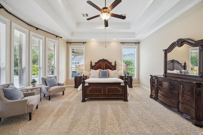 Fabulous Primary Retreat with high triple tray ceilings, seating area and a view of the backyard paradise from every angle! | Image 20