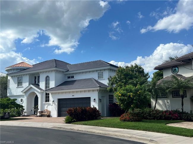 Mediterranean / spanish house featuring a front lawn, driveway, a garage, and stucco siding | Image 40