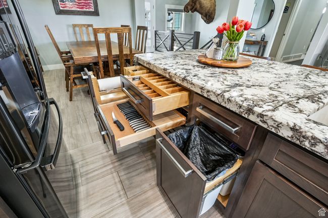 Kitchen with freestanding refrigerator and light stone countertops | Image 31