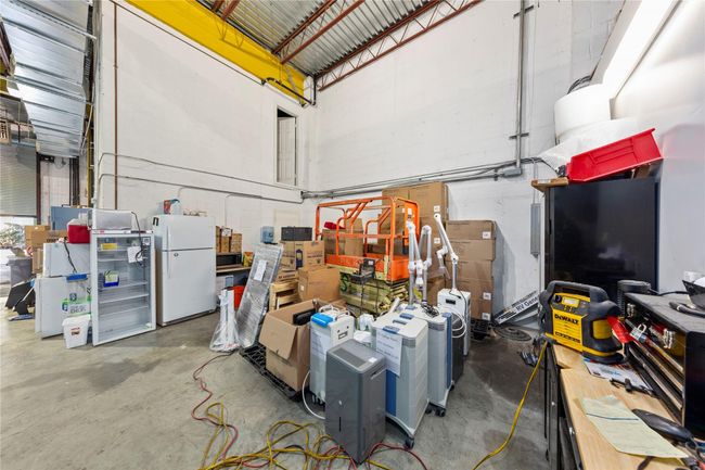 Garage featuring white refrigerator | Image 32