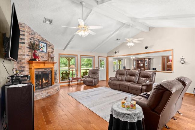The space is accented with warm wood floors, creating a perfect setting for relaxation and entertainment. | Image 4