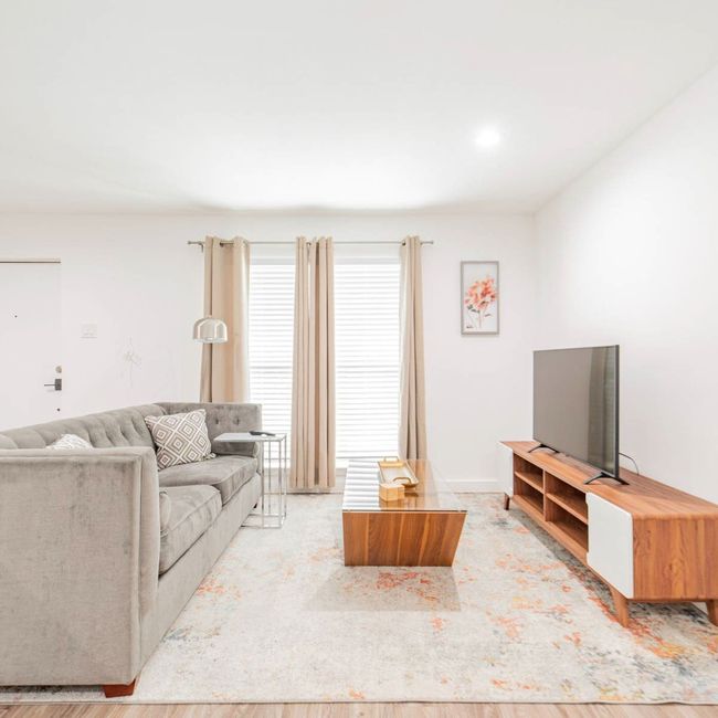 Living area with wood finished floors | Image 7