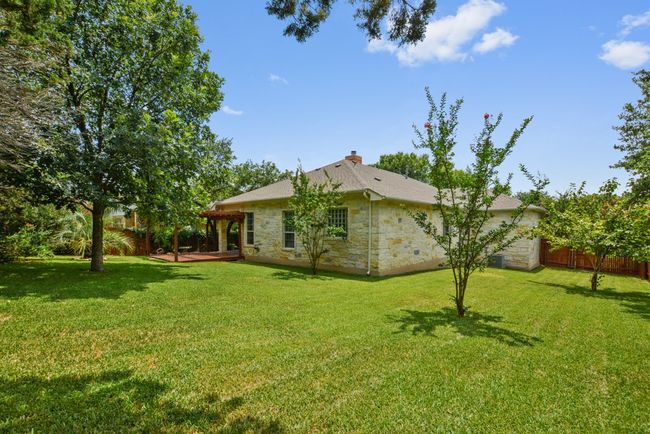 Step outside to your private backyard haven, where a pergola-covered deck and patio create the ideal setting for al fresco dining, morning coffee, or relaxing under the Texas sky. | Image 34