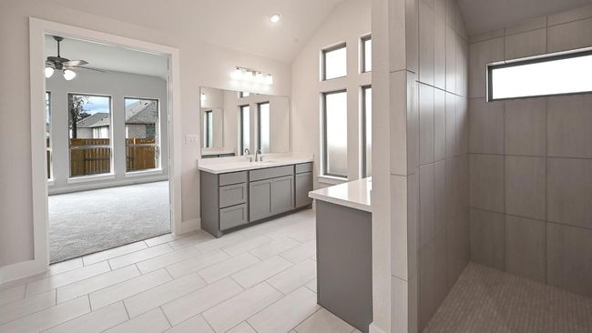 Full bath with vanity, light tile patterned flooring, recessed lighting, vaulted ceiling, and light carpet | Image 20