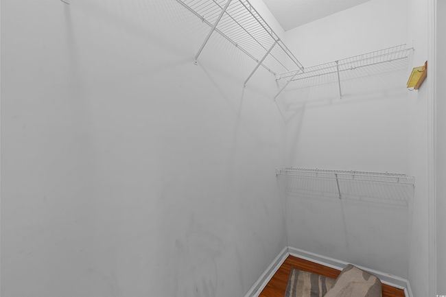 Spacious closet with wood finished floors | Image 30
