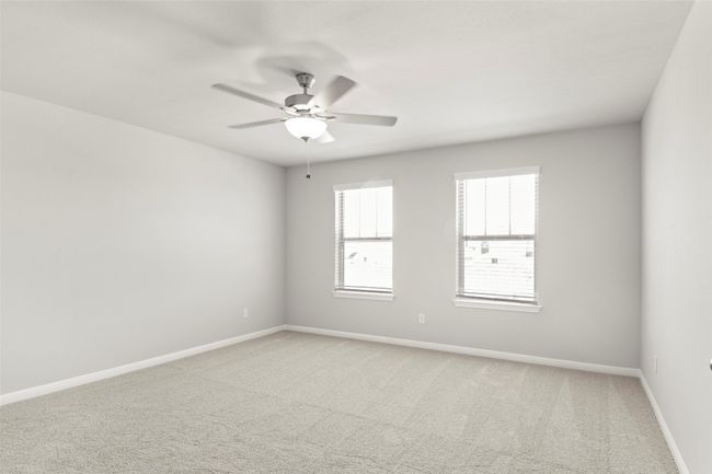 Spare room featuring light carpet, ceiling fan, and baseboards | Image 21