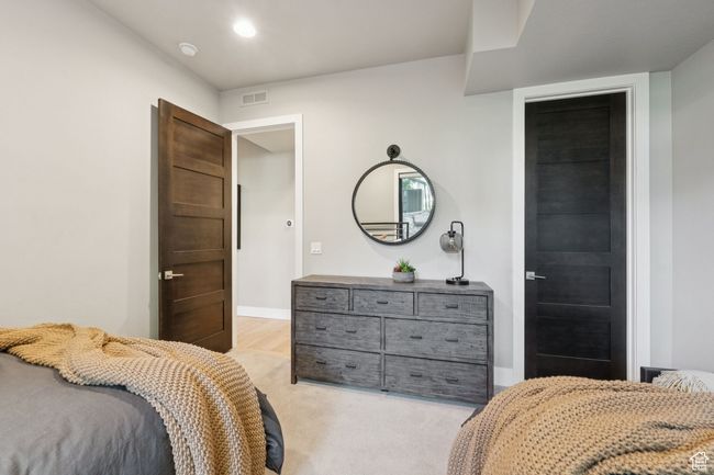 Bedroom with light colored carpet and baseboards | Image 19