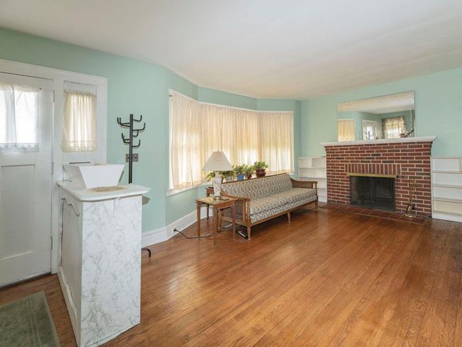 Living room with hardwood / wood-style floors, plenty of natural light, and a brick fireplace | Image 12