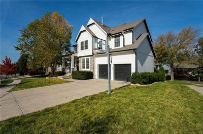 View of front of home with a front yard and a garage | Image 3