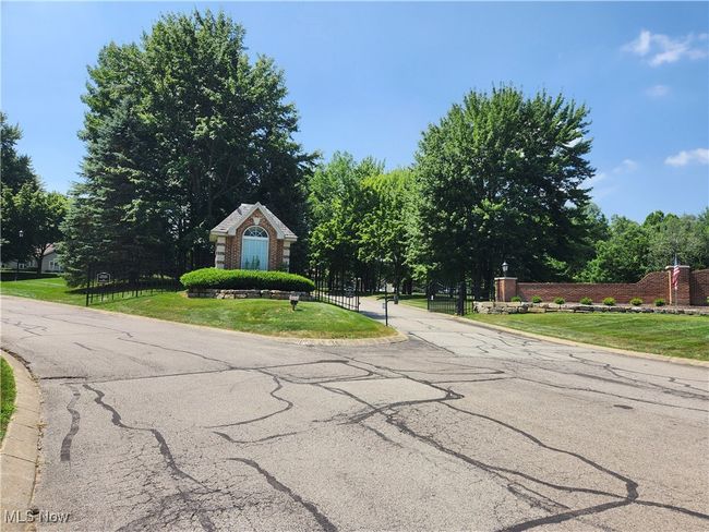 Gated drive coming into the condo development | Image 37