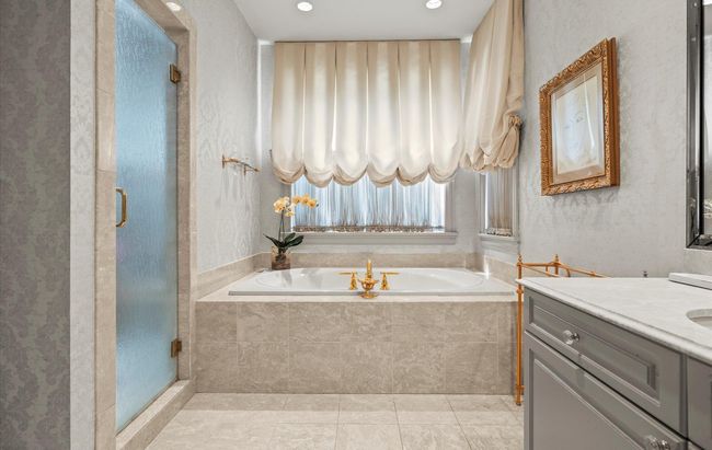 Bathroom with a bath, vanity, a shower stall, and tile patterned flooring | Image 23
