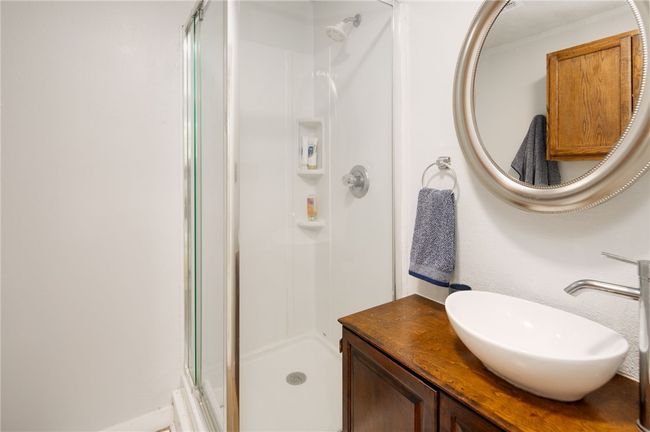 Bathroom featuring a stall shower and vanity | Image 13