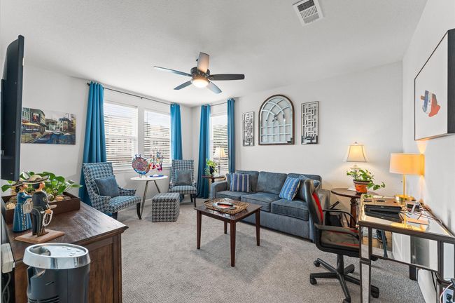 Perfect for working from home or unwinding, this flexible room offers seating, workspace, and great natural light from corner windows. | Image 17