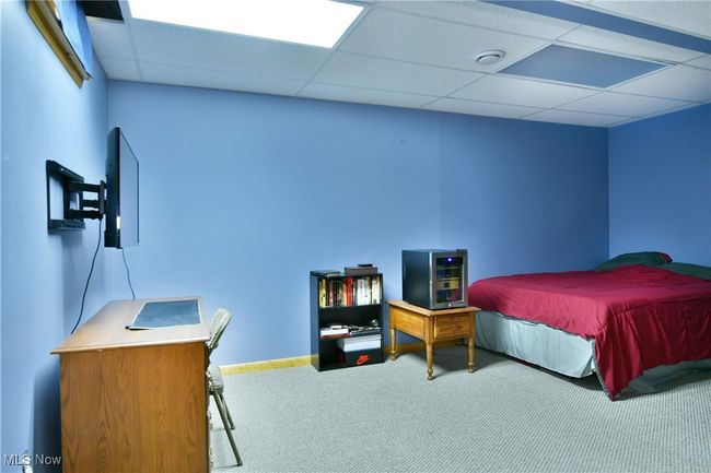 Carpeted bedroom with a drop ceiling | Image 45