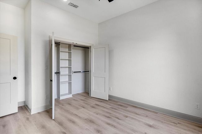 Unfurnished bedroom featuring light wood finished floors and a closet | Image 37