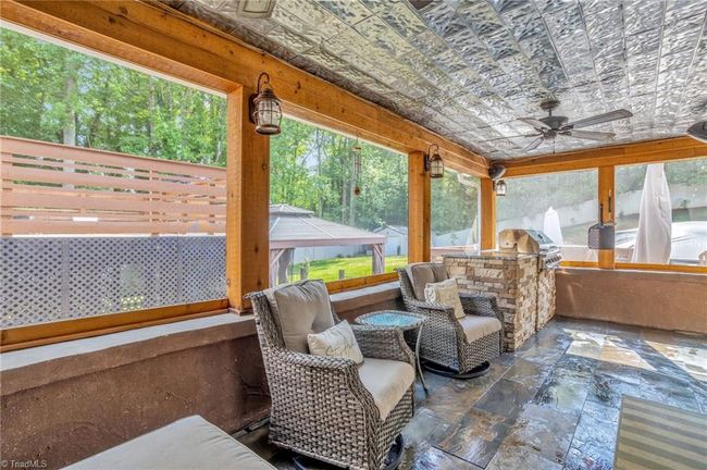 Spacious screened porch off den with sitting area | Image 24