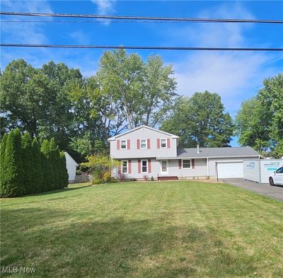 View of front of property featuring a front yard and a garage | Image 2