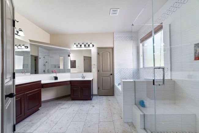 Bathroom featuring double vanity, a stall shower, and a garden tub | Image 22