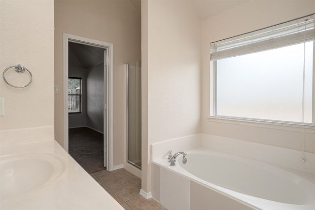 Bathroom featuring healthy amount of natural light, separate bath & shower | Image 23