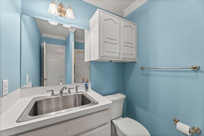Bathroom featuring toilet, vanity, and a shower | Image 19
