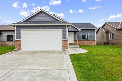 View of front of house featuring a garage, central air condition unit, and a front lawn | Image 2