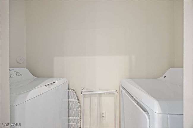 Washroom with washing machine and clothes dryer and laundry area | Image 11