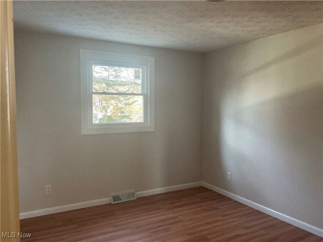 Spare room with hardwood / wood-style floors and a textured ceiling | Image 8