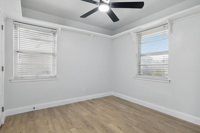 Spare room with baseboards, a ceiling fan, and light wood-style flooring | Image 15