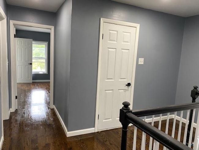 Spare room featuring dark wood-type flooring and plenty of natural light | Image 30