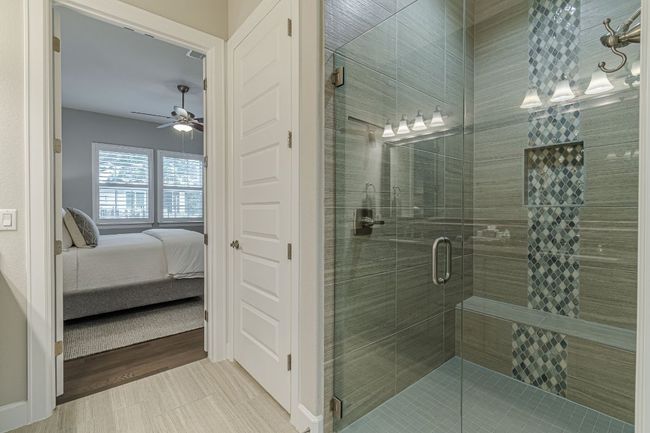 Bathroom featuring ensuite bath, ceiling fan, a stall shower, and tile patterned flooring | Image 30